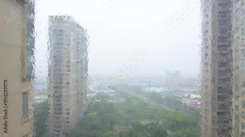 a typhoon rages outside the high-rise window at horizontal composition video with sound