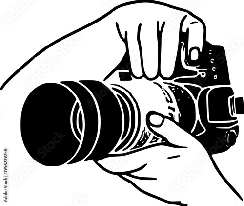 Hand holding a digital camera with a large lens for photography