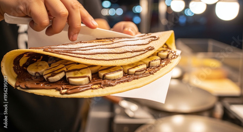 Wallpaper Mural Hands Holding a Delicious Banana Chocolate Crepe with Powdered Sugar at a Night Market Stall Torontodigital.ca