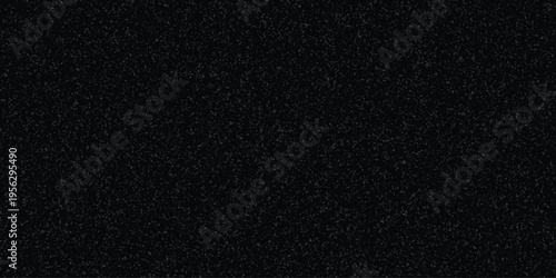 Dark speckled texture background with subtle gray granular pattern for abstract design and grunge effects