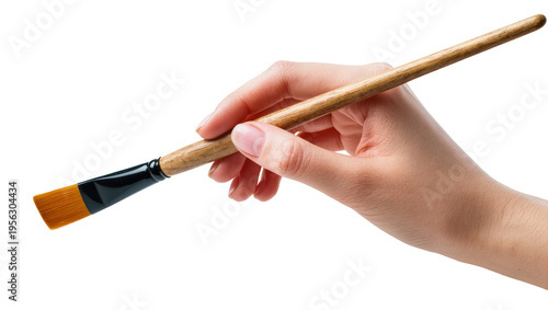 Fotografie Isolated human hand holding a flat artist's paintbrush with orange synthetic bristles, ready to create