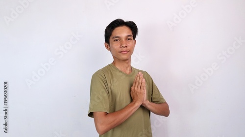 Canvas Print Asian young man smiling greeting gesture