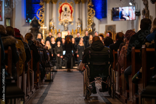 Canvastavla Interior of a church during a choir concert with audience in pews and a person in a wheelchair in the aisle, Poland