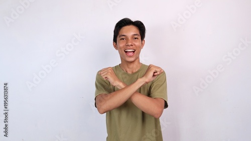 Asian young man gesturing with both hands crossed, rejection
