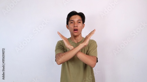Asian young man gesturing with both hands crossed, rejection