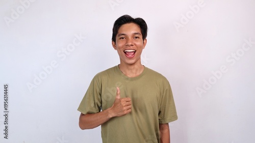 excited asian young man gesturing okay