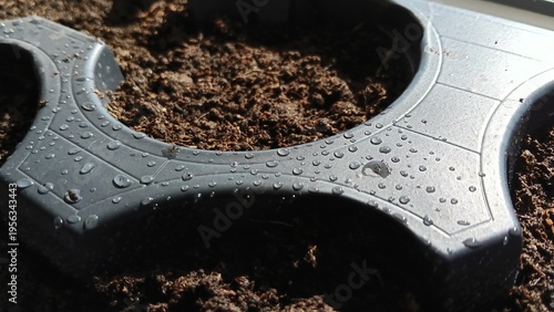 Close-up of wet soil in plastic garden pots
