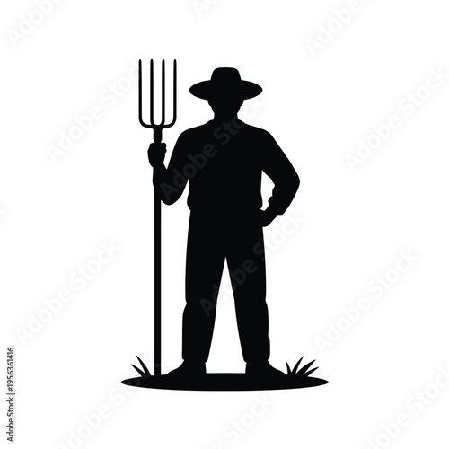 Silhouette of a farmer holding a pitchfork in a field
