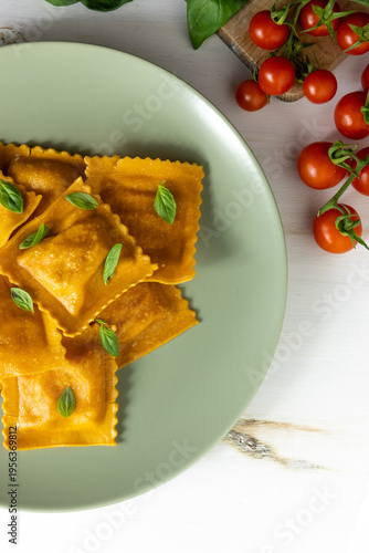 Minimal ravioli plate with basil and copy space, Italian food background