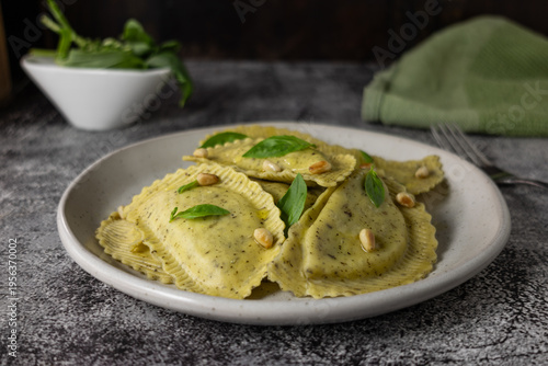 Italian ravioli with pesto sauce and basil on plate, gourmet food lifestyle concept