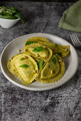 Italian ravioli with pesto sauce and basil on plate, gourmet food lifestyle concept