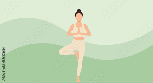 Woman gracefully practices tree pose during a mindful yoga session at a verdant backdrop