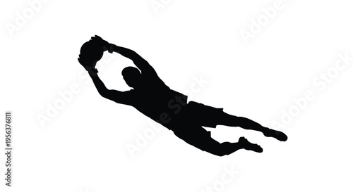 Silhouette of a goalkeeper diving to save a soccer ball