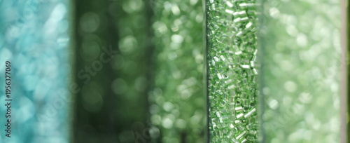 Rows of emerald and teal glass bugle beads for sustainable jewelry design and handmade accessories.