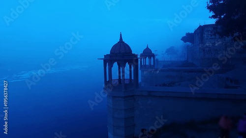 Scenic view of Brahmand Ghat on Yamuna river in Mathura, Uttar Pradesh during foggy morning. Historic riverside monument with peaceful spiritual atmosphere, showcasing Indian culture, heritage.