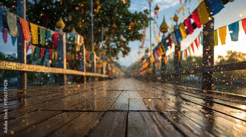 Songkran Water Festival at chiang mai festival bridge walkway colorful festival flags fluttering water drops splashing onto wooden bridge