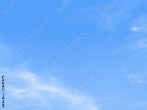 Abstract bright blue sky background with soft white wispy clouds and copy space