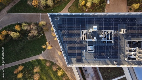 Modern Building Rooftop With Solar Panels and Vibrant Autumn Trees