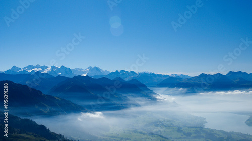 Fotografie Majestic Alpine Peak Above a Sea of Clouds
