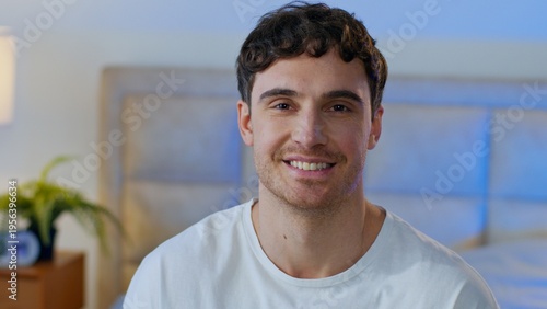 Happy Caucasian man smiling looking at camera portrait male enjoy positive friendly mood at home glad homeowner guy bedroom weekend wellbeing laughing enjoying relaxation domestic lifestyle indoors
