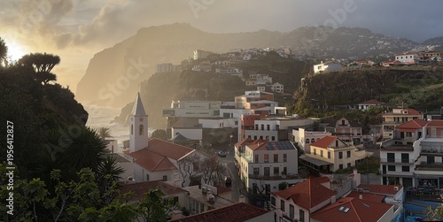 Panoramic view of Camara de Lobos village with Sao Sebastiao church and Cabo Girao cliff at sunset, Madeira Island, Portugal