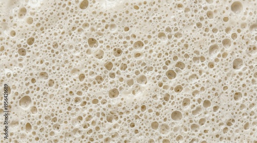 Fine bubble coconut yogurt surface macro background. Vegan dairy free yogurt foam texture concept.