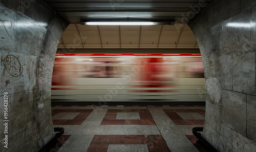Train passing in a brutalistic subway station. Ultra wide shot with moving train.