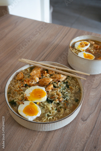 Delicious chicken ramen with soft boiled eggs and crispy onions served in a bowl