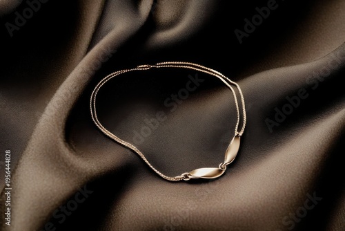 Elegant gold chain necklace on satin fabric background for jewelry display banner and luxury product design