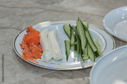 A plate with ingredients for making sushi. Close-up. Soft focus