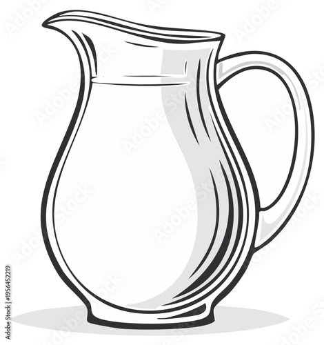 Elegant clear glass pitcher filled with white liquid stands ready to be poured