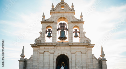Church wedding displaying an old historic stone facade with tall bell towers. The majestic building stands as a breathtaking destination for a religious matrimony ceremony.