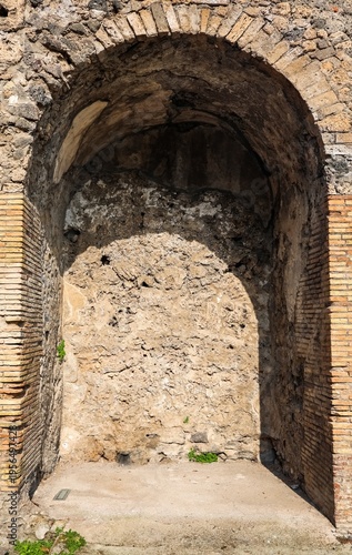 Ancient Roman arch niche wall in Pompeii ruins