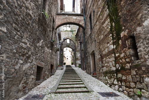 Picturesque alley with stairs in the medieval town of Narni. Umbria region, central Italy. Medieval city: a typical old street. Holidays in Italy. Ancient italian city rich in history. A cobblestone s