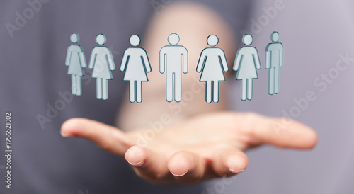 Tableau sur toile A conceptual image of a hand holding several human figure symbols, representing