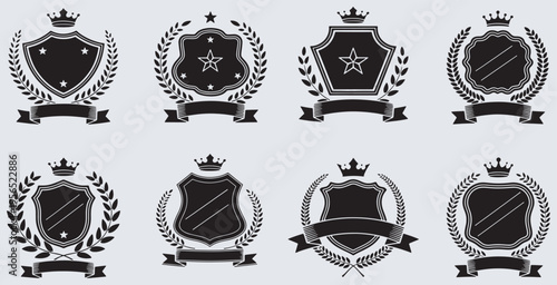 Set of eight elegant black and white shield emblems with crowns, stars, and laurel wreaths, perfect for branding and design projects.
