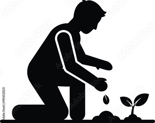 A man planting a seedling in the ground