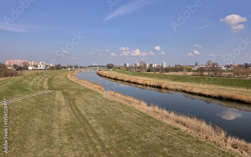 Quadro su tela Odra River with flood embankments and Opole city skyline in spring