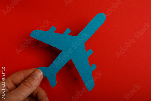 Hand holding a blue paper a...