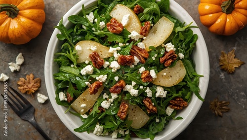 nutritious autumn salad featuring arugula, pear, cheese, and sweetened walnuts