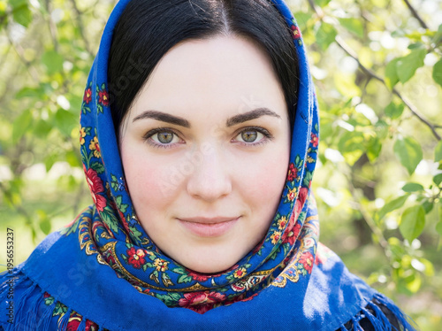 Portrait of a young beautiful woman with a scarf on her head