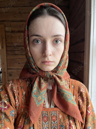 Portrait of a young beautiful woman with a scarf on her head