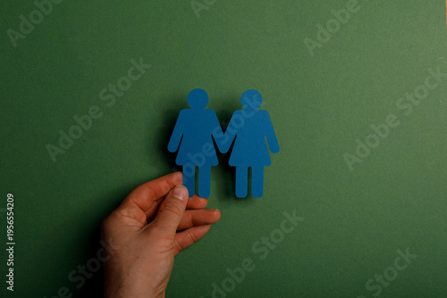 Hand holding paper cut-outs...