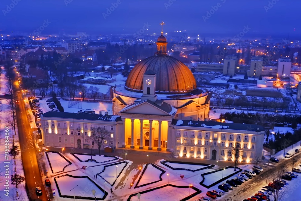 Obraz premium Aerial winter view of illuminated basilica at blue hour in Lichen Stary, Poland