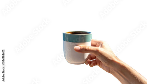 Hand holding a mug of dark liquid against a black background. Minimalist composition