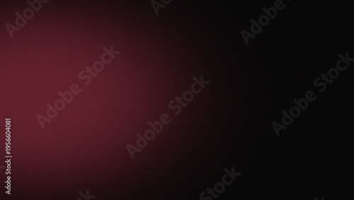 A textured abstract background with a smooth gradient transitioning from a vibrant, dark red to a profound, mysterious black shade