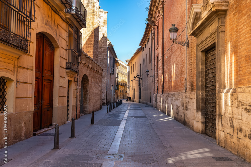 Fototapeta premium Narrow picturesque streets with old stone buildings in the centre of Valencia, Spain.
