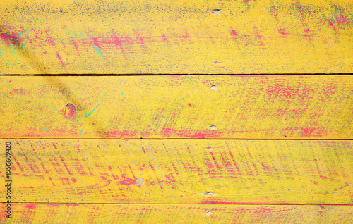 Bold yellow wooden texture with red paint splatters