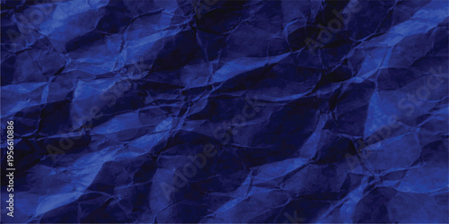 Deep blue abstract background showing a textured surface with soft folds and shadows in dark tones