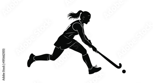 Female athlete silhouette runs forward powerfully while dribbling a small ball with a curved stick during a field hockey match.